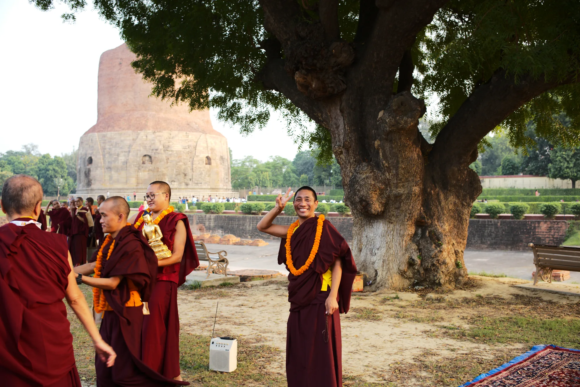 Monks smiling at Dhamek Stupa